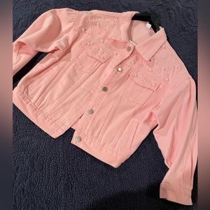 Women’s pastel pink jean jacket with pearl detail and pleated puff sleeve.
